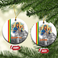 Round white ceramic Christmas ornament with Saint Mary and church design, gold hanging loop