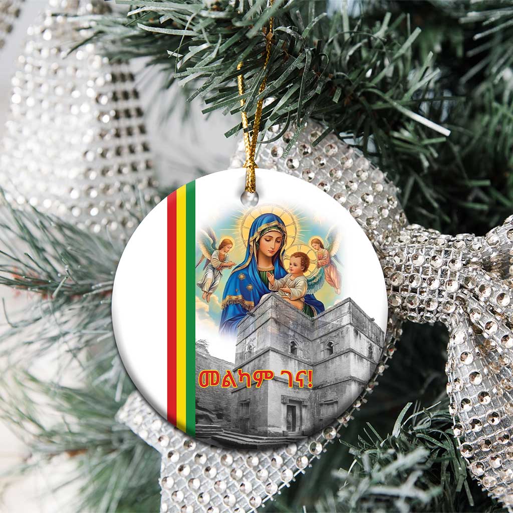 Round white ceramic Christmas ornament featuring Saint Mary and church scene, gold hanging loop