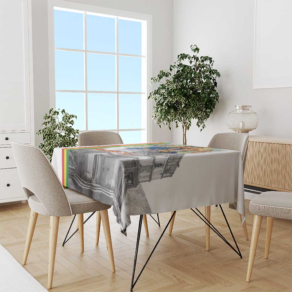 Christmas tablecloth draped on dining table, featuring Saint Mary and church scene