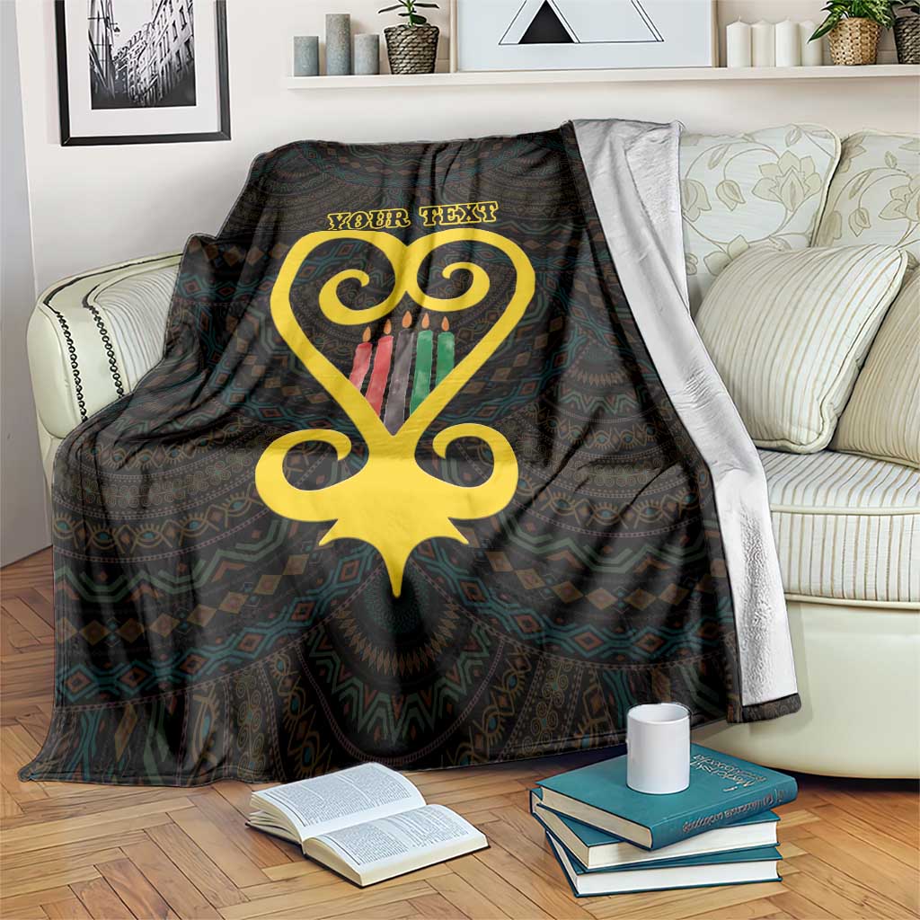 Personalised blanket with dark Adinkra-style pattern, gold heart, and 'YOUR TEXT' print.