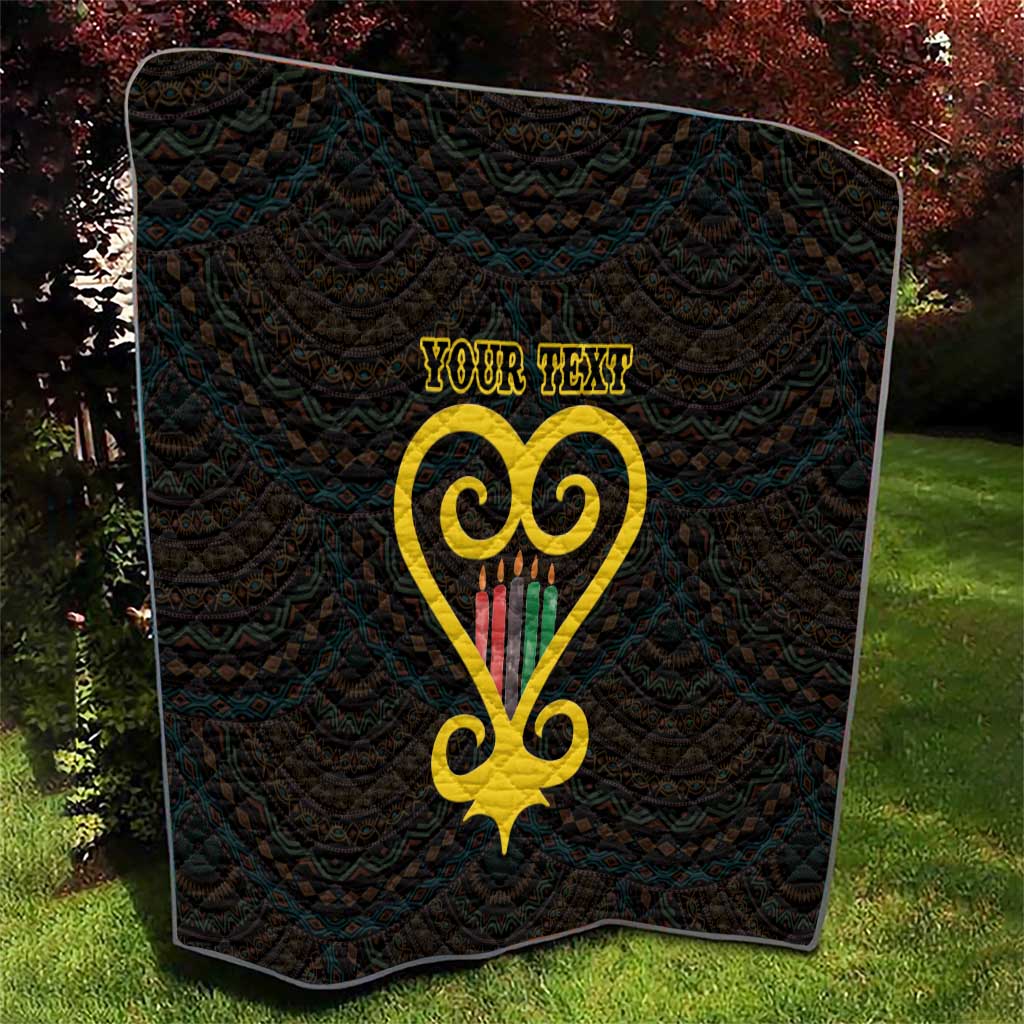 Black quilt with diamond stitching and yellow Adinkra heart motif above 'YOUR TEXT'.