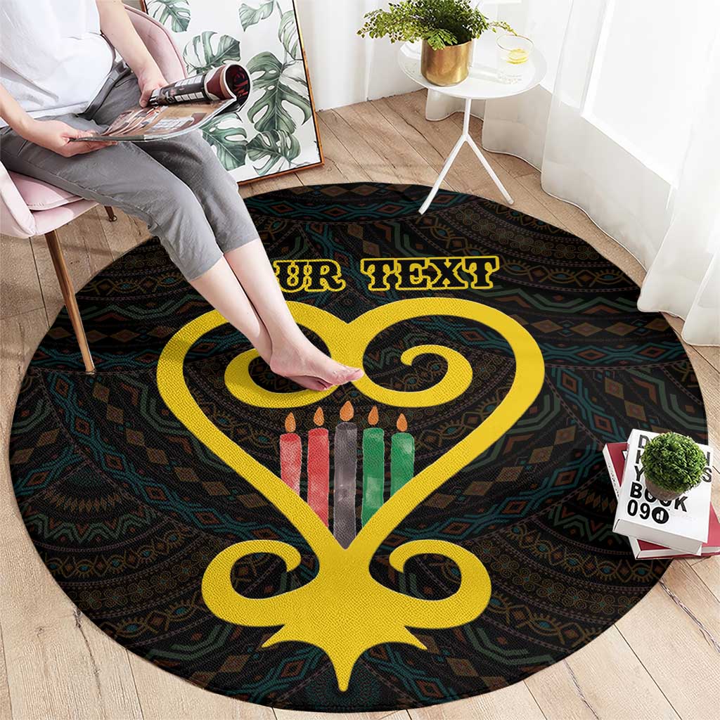Black round rug with yellow Sankofa heart and Adinkra pattern; “YOUR TEXT” banner