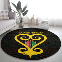 Black round area rug featuring a yellow Sankofa heart, multicolor candles, Adinkra pattern