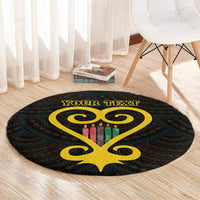 Black round rug with yellow Sankofa heart center and Adinkra-style border, candle graphic