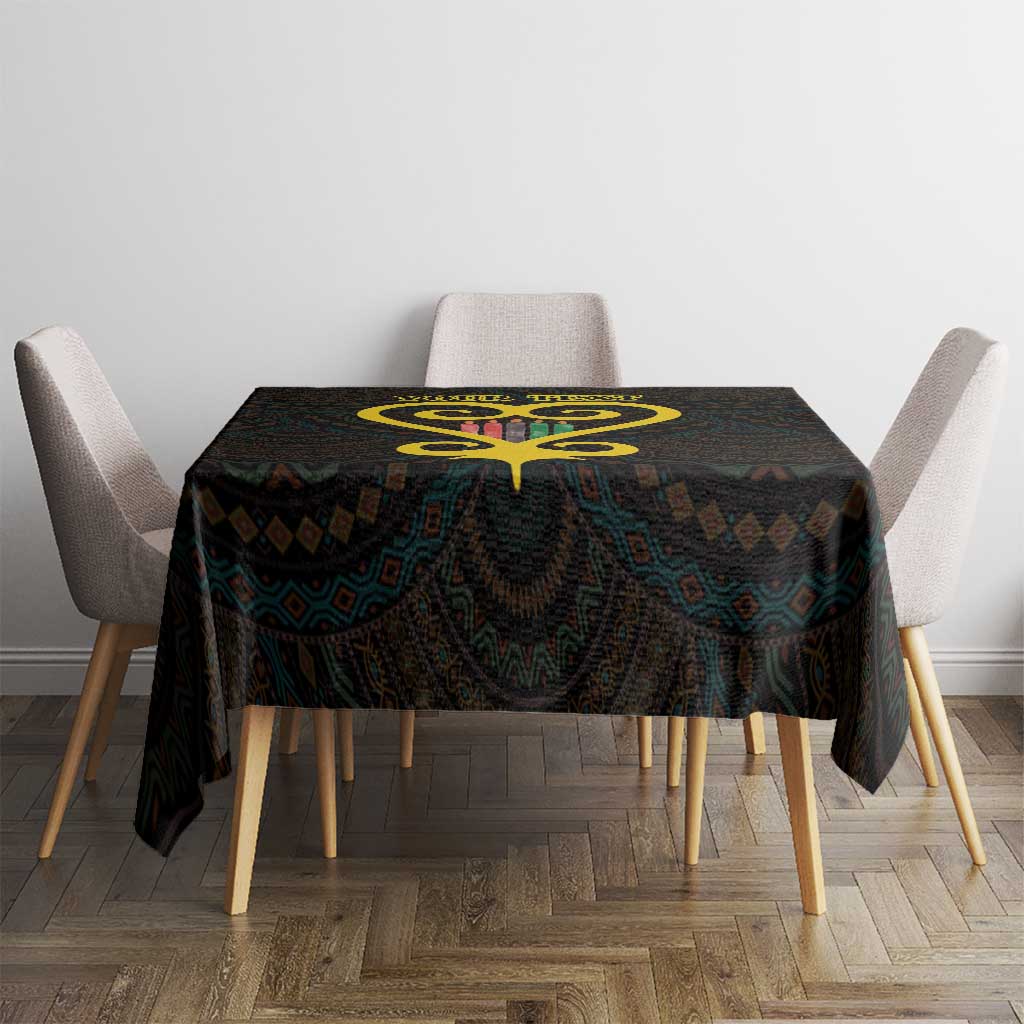 Black tablecloth with gold heart symbol and colorful geometric Adinkra-style print on table