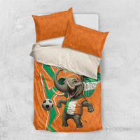 Orange football bedding set with elephant soccer print and two orange pillows