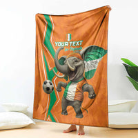Orange football blanket featuring elephant in green-white kit, waving flag and soccer ball