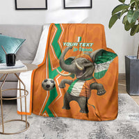 Orange football blanket on floor, elephant in green scarf with soccer ball and your text
