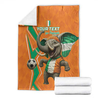 Orange football blanket with elephant soccer player graphic, folded with white roll towels