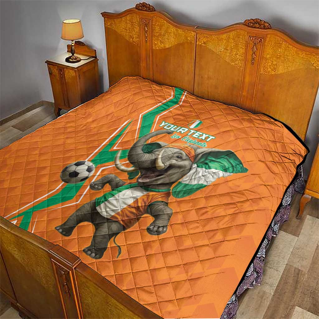 Orange quilt covering bed with elephant football graphic and green-white side stripe
