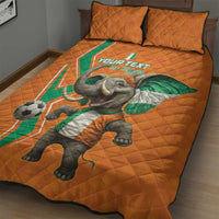 Orange football quilt bed set with elephant and football print, two pillows on top.