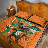 Orange football quilt bed set with elephant holding flag, 'Les Elephants' text, two pillows.