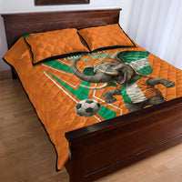 Orange football quilt bed set with elephant and football print, two matching pillows.