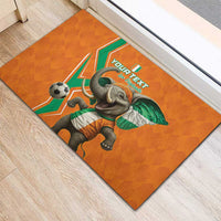 Orange rubber doormat with elephant kicking football and custom text on top