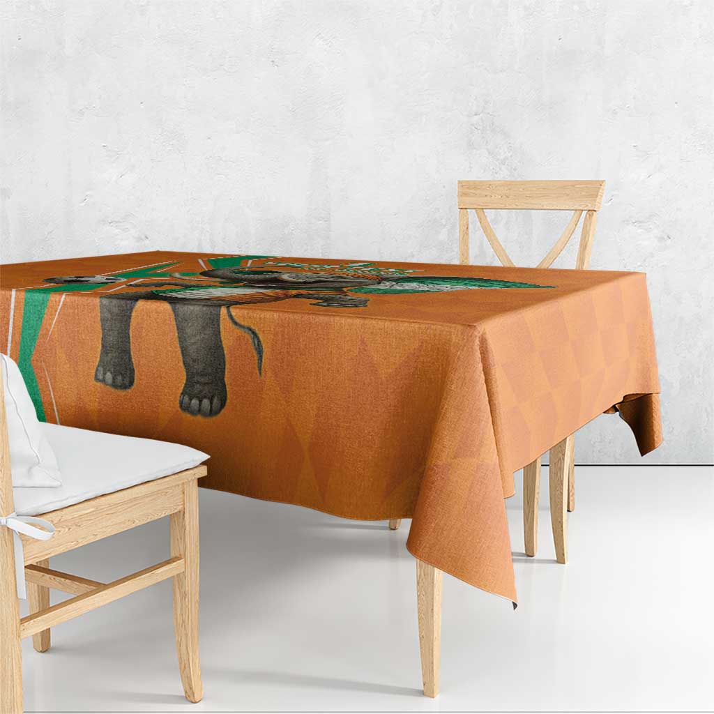 Orange tablecloth with elephant graphic and green accent border over a dining table