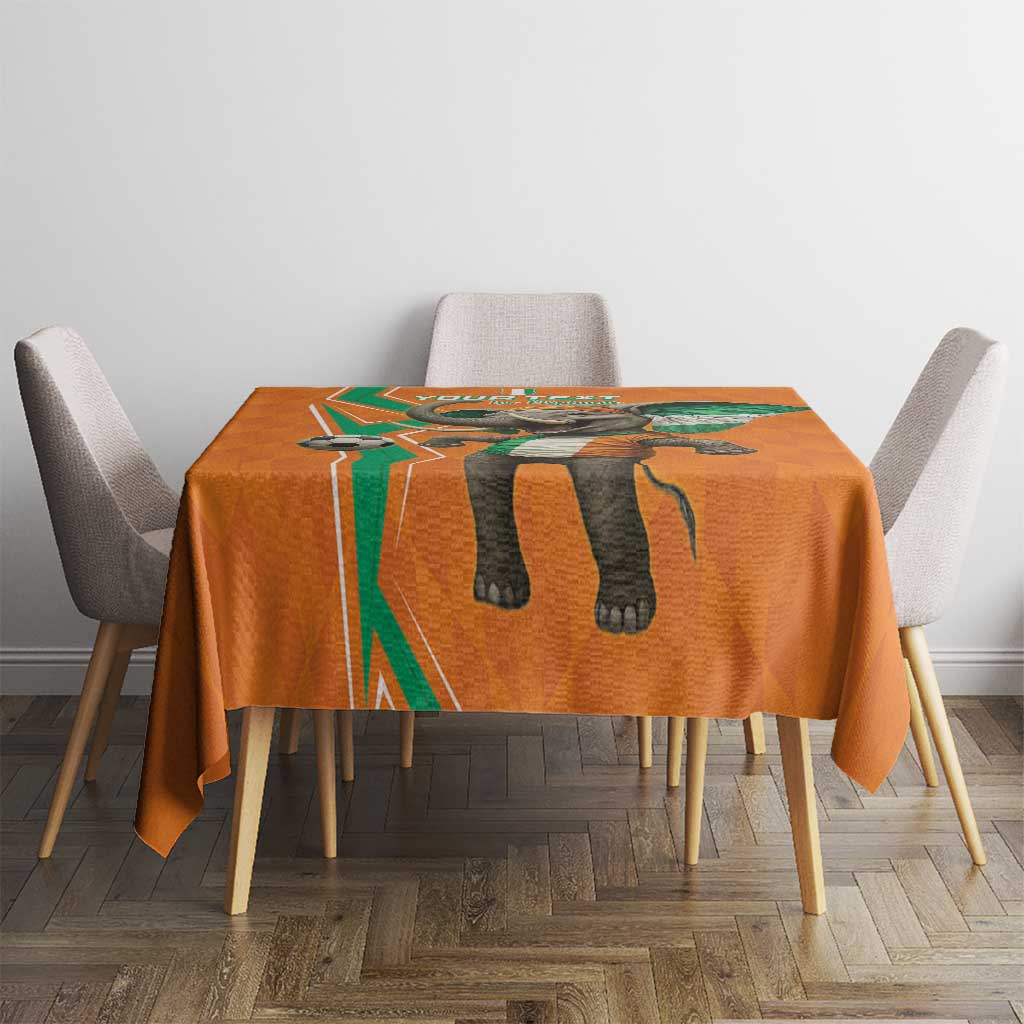 Orange football tablecloth with elephant artwork centered on a small dining table