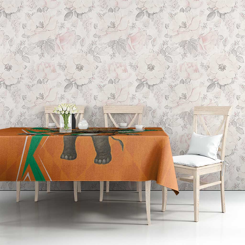 Orange football-themed tablecloth with elephant design on dining table