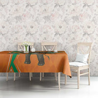 Orange football-themed tablecloth with elephant design on dining table