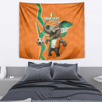 Orange football tapestry with baby elephant in green-and-white jersey and soccer ball.