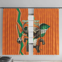 Orange window curtains with green-white elephant graphic and football design panels