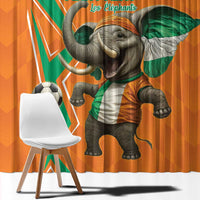 Close-up of orange curtain fabric with large elephant holding a green scarf and football
