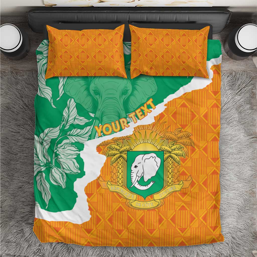 Orange, green and white Ivory Coast bedding set with elephant crest and two matching pillows.