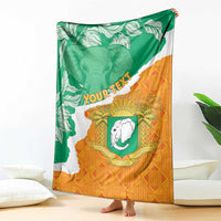 Custom throw blanket draped with Ivory Coast map and green/orange elephant emblem