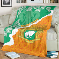 Custom throw blanket on couch with Ivory Coast map, green/orange elephant coat of arms