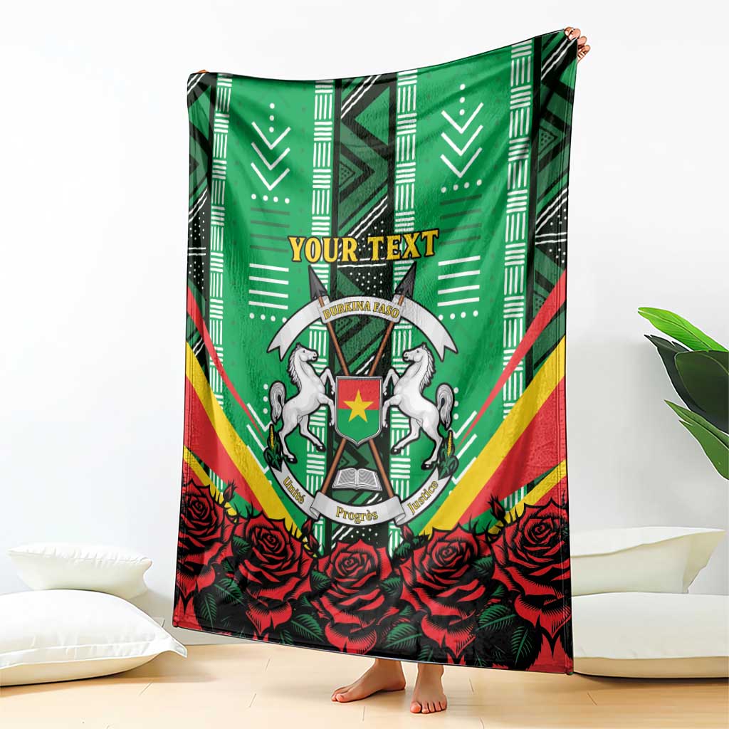 Green throw blanket with central crest, red rose pattern, and “YOUR TEXT” header