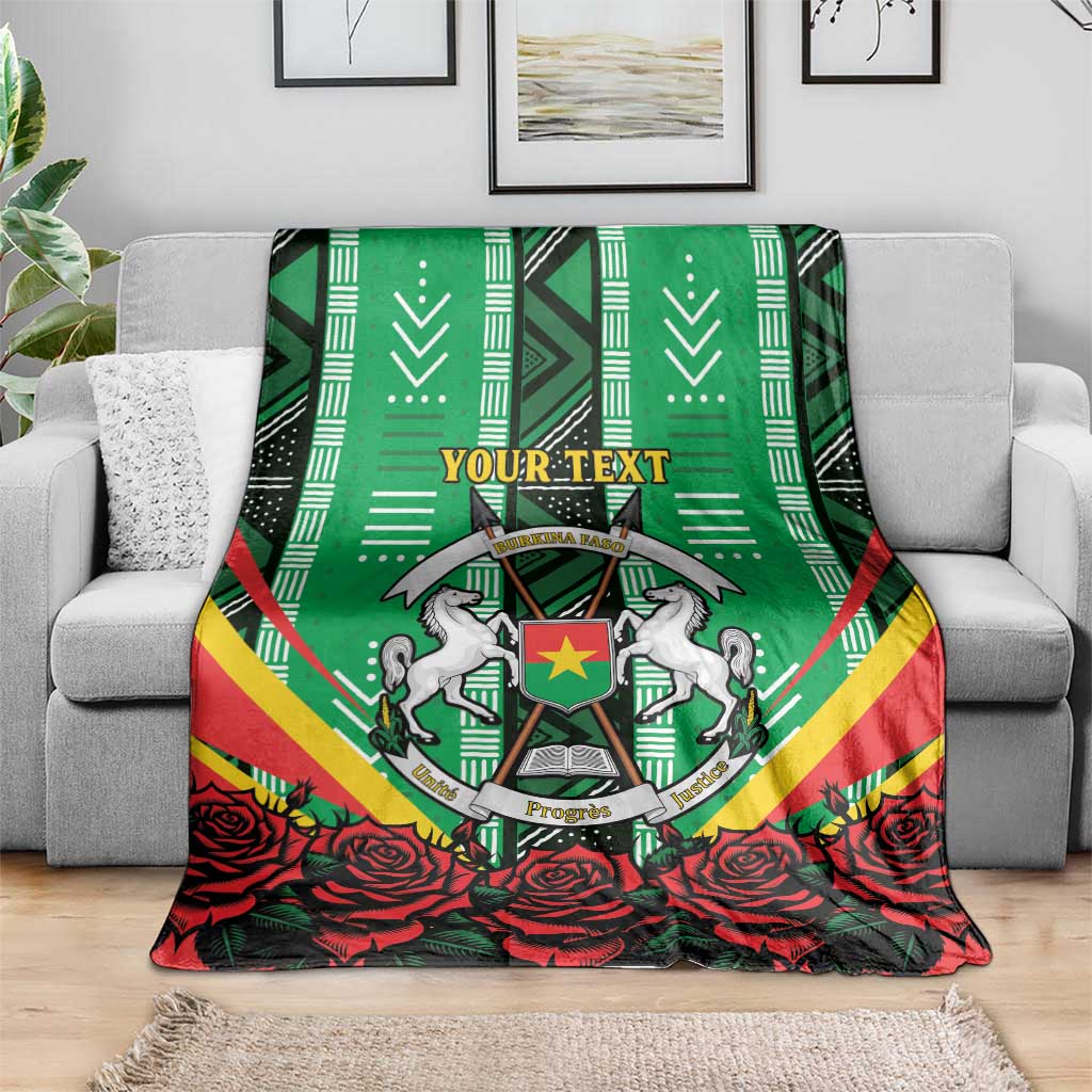 Green personalised blanket with coat of arms emblem and red roses along bottom edge