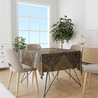 Brown batik tablecloth with gold and dark floral motifs, draped over dining table