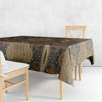 Brown batik tablecloth with gold vine and paisley motifs along the table edge