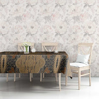 Brown batik tablecloth with gold detailing and dark floral motifs over dining table