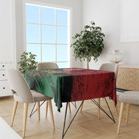 Red and green Kenya-themed tablecloth with emblem on dining table