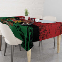Red and green tablecloth with Kenya emblem draped over dining table