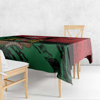 Red and green Kenya-themed tablecloth with crest near table edge