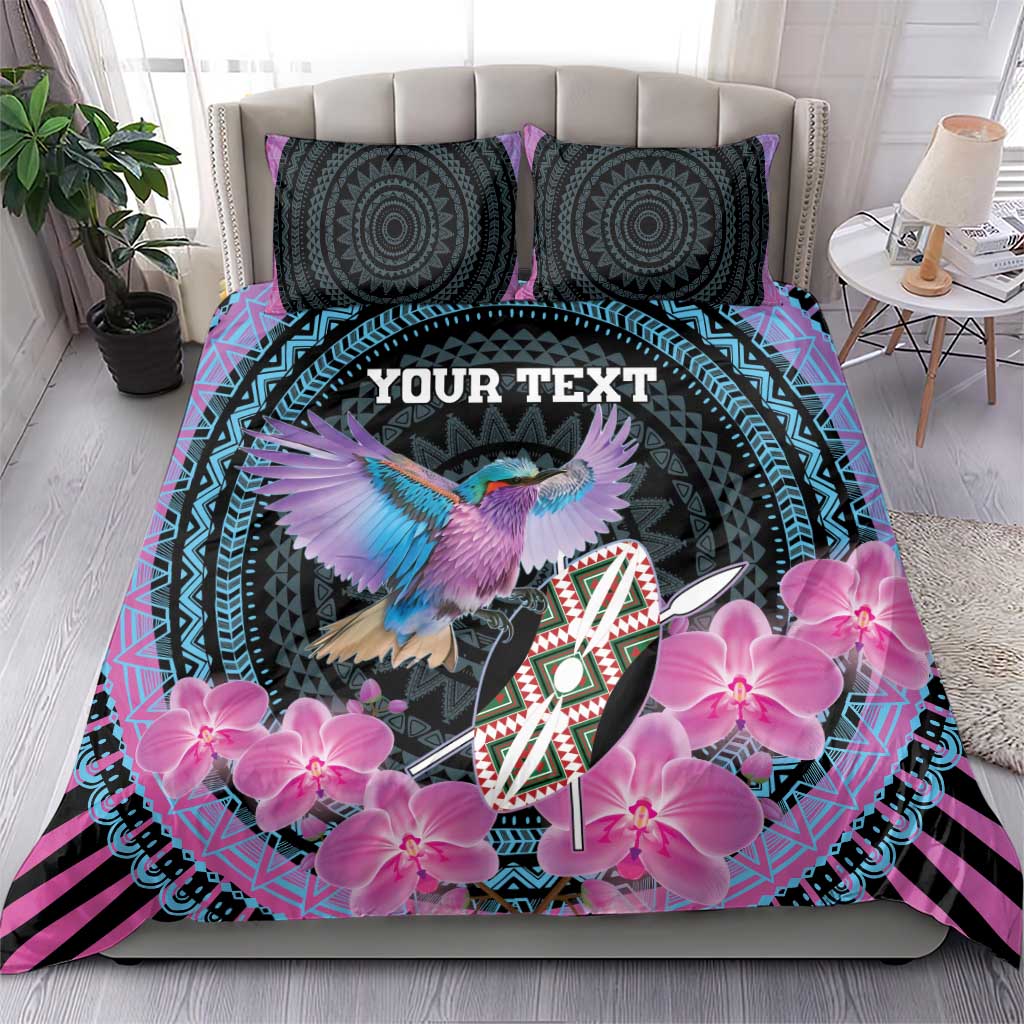 Purple and black duvet set with two patterned pillows, pink orchids and bird shield artwork