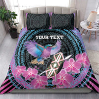 Purple and black duvet set with two patterned pillows, pink orchids and bird shield artwork
