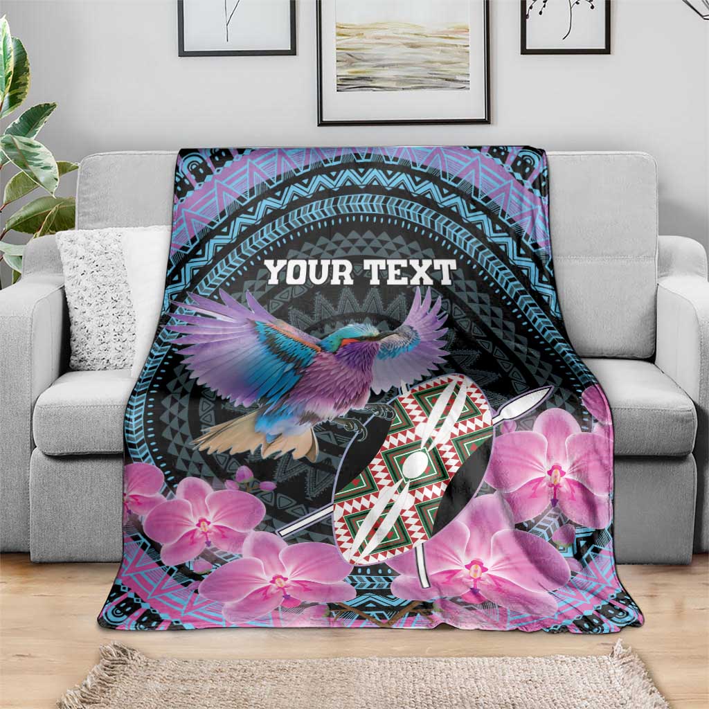 Personalized roller blanket on sofa, purple orchids and bird on black with 'YOUR TEXT'