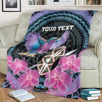 Personalized roller blanket draped on couch, purple orchids, bird, teal patterns, 'YOUR TEXT'