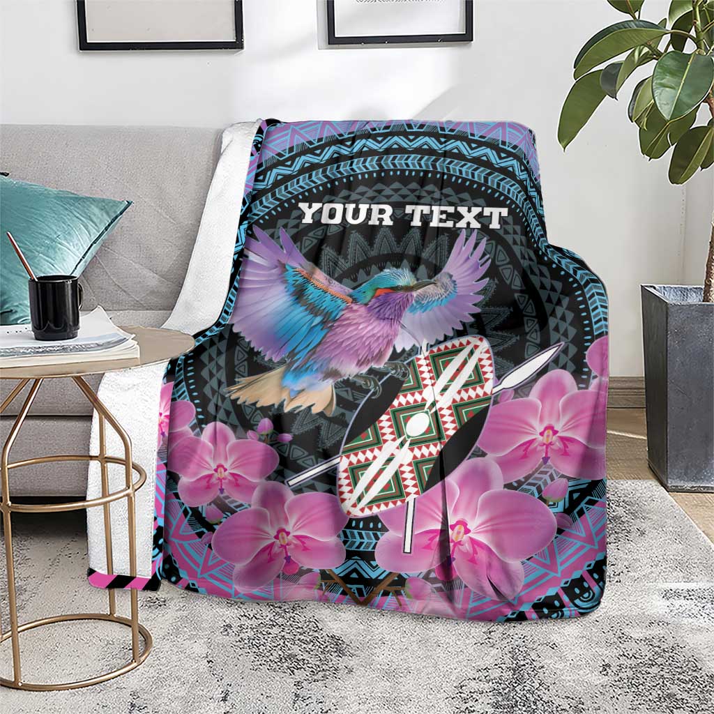Personalized roller blanket on floor, purple orchid flowers and bird on black with teal trim, 'YOUR TEXT'