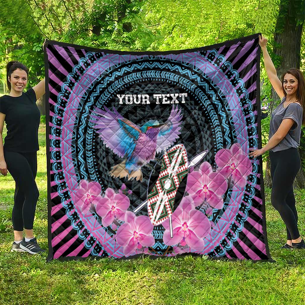 Personalized quilt with circular turquoise border, bird, pink flowers, and “YOUR TEXT” on black