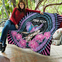 Personalized quilt held out; purple and turquoise rings, bird, pink flowers, “YOUR TEXT”