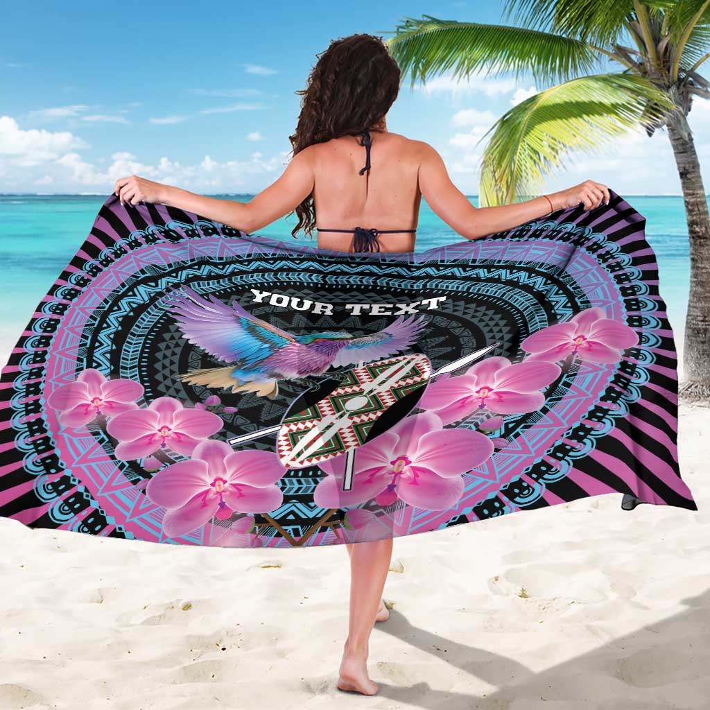 Personalized sarong showing “YOUR TEXT” in teal, with bird and pink orchids on black