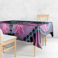 Orchid and geometric patterned tablecloth hanging over table edge, purple and cyan