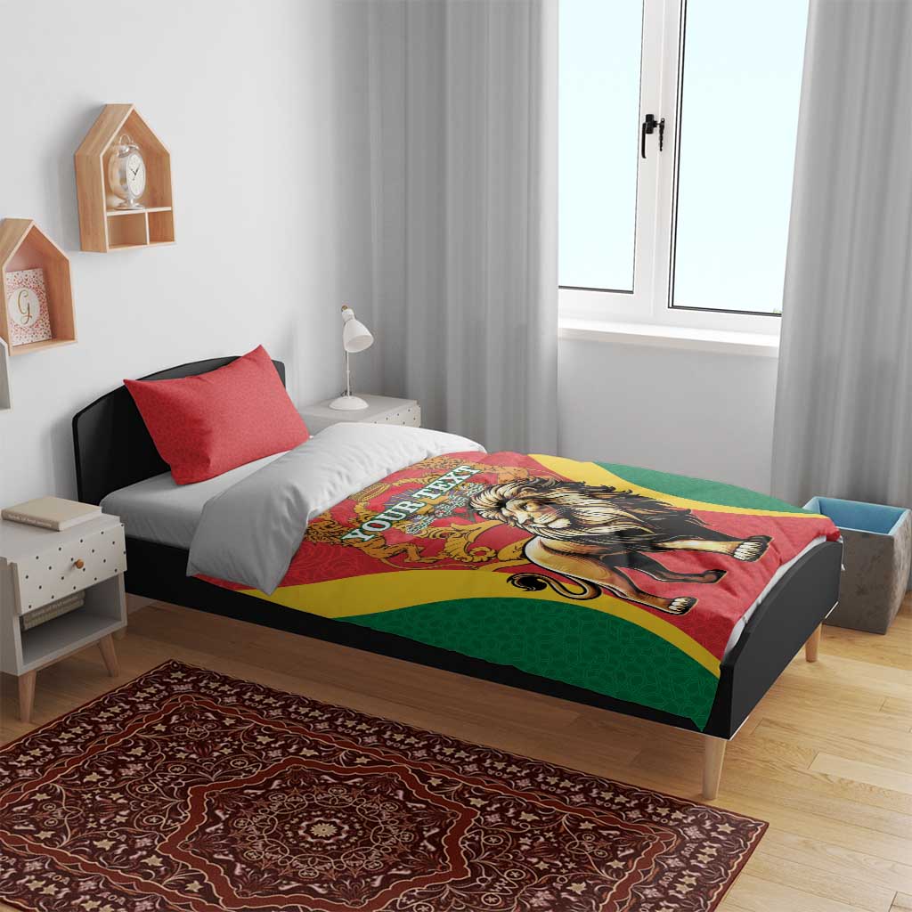 Red duvet bedding set on bed with two red pillows, lion and crown graphic, green and yellow accents