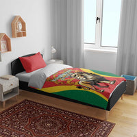 Red duvet bedding set on bed with two red pillows, lion and crown graphic, green and yellow accents