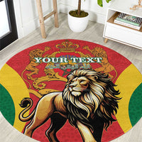 Close view of red round rug featuring lion portrait and gold crown medallion