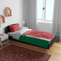 Red and green football duvet on bed with tricolor stripe and lion print, red accent pillow