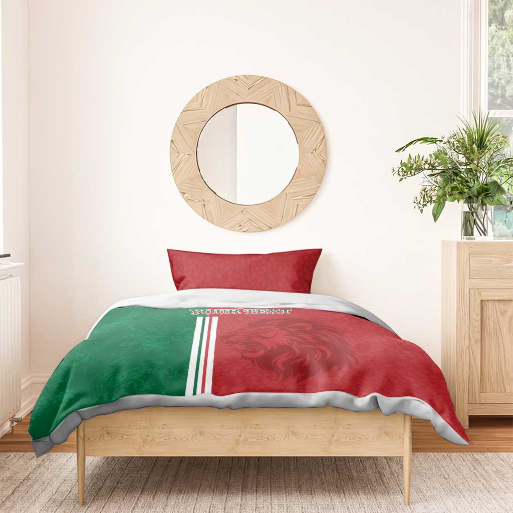 Red and green football duvet with tricolor stripes and lion print on bed with one red pillow